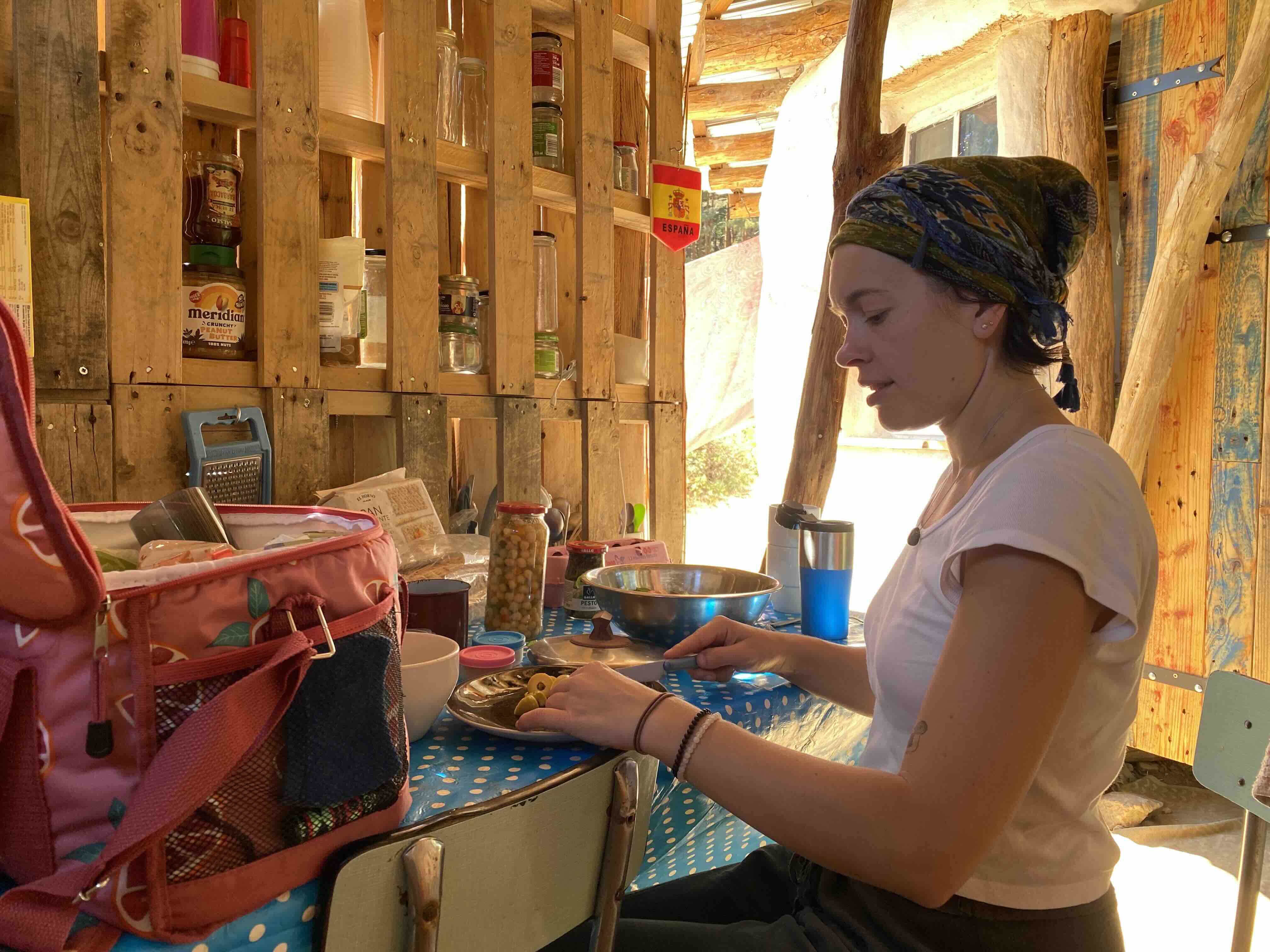 Helene preparing food in a warm wooden kitchen